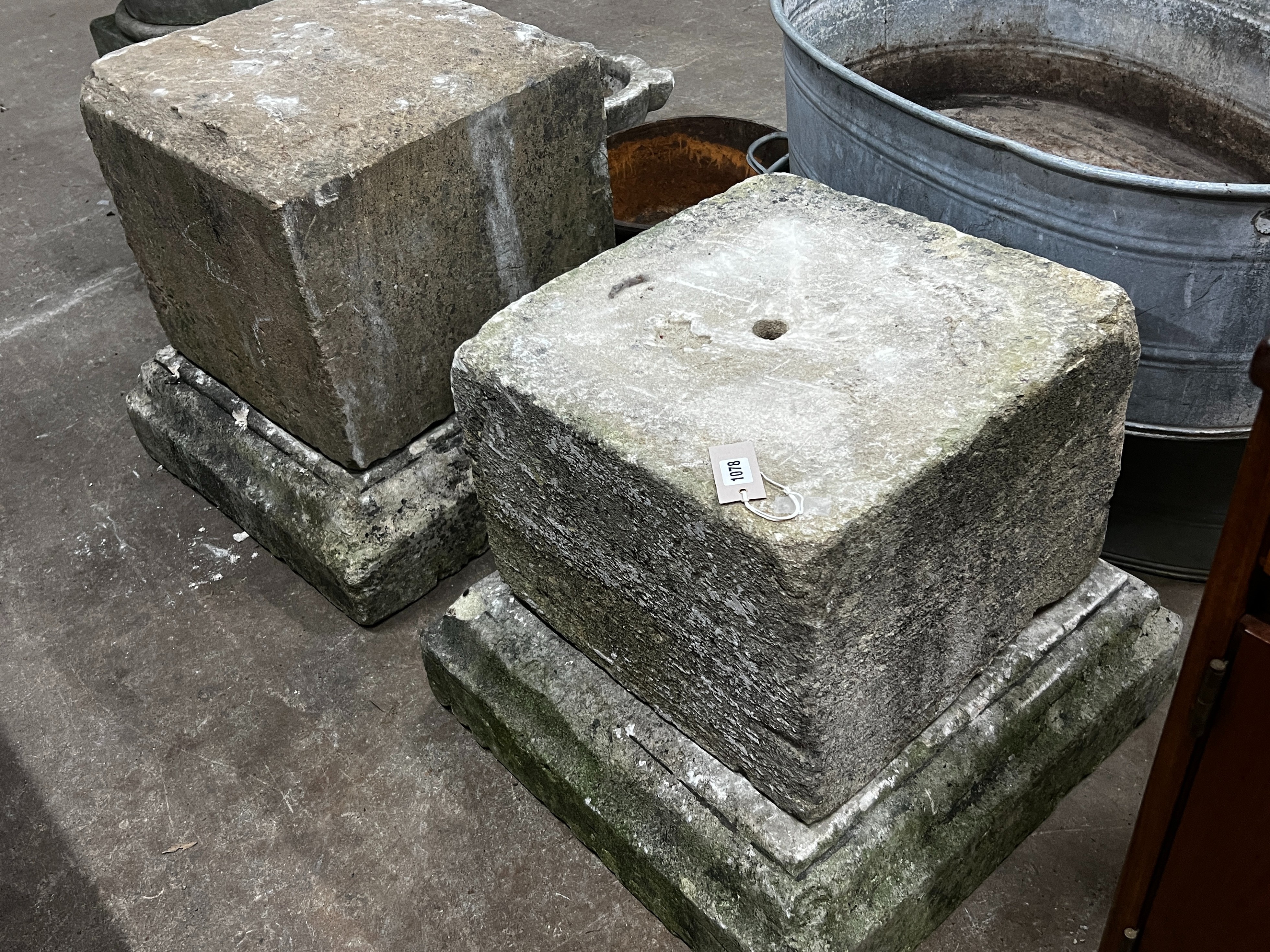 A near pair of carved stone plinths on bases, larger width 59cm, height 58cm